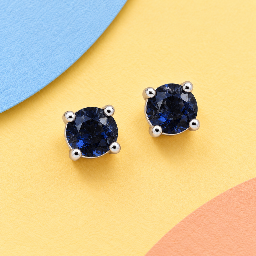K1034: one pair of 4 mm round blue sapphire ear studs in four claws 925 sterling silver settings.