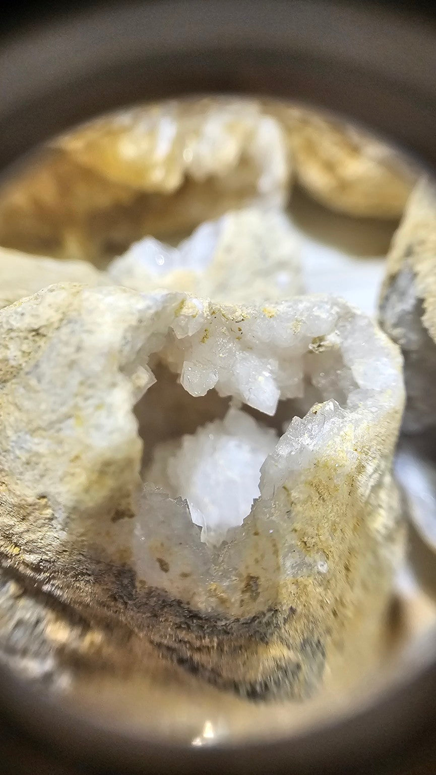 Crystal details in a geode viewed through The Gem Museum 10× triplet loupe